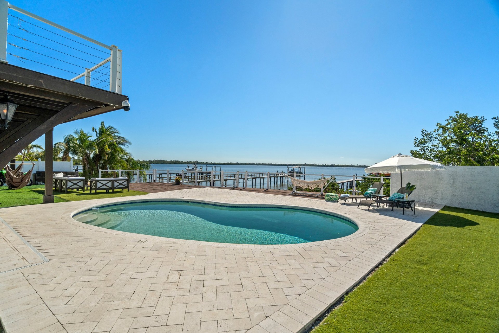 Pool, private beach, patio, and waterfront outdoor area at St Pete Waterfront Mansion